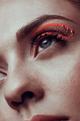 woman orange makeup blue eye